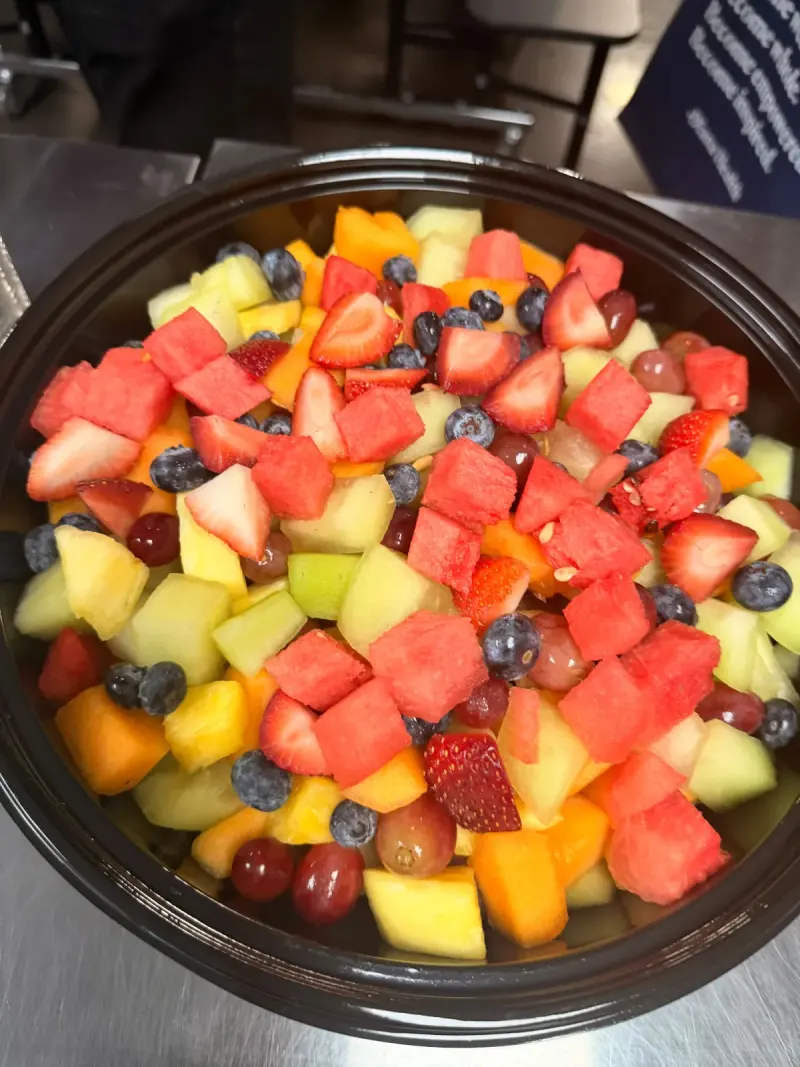 A close-up of a bowl of fruit salad: watermelon, strawberries, blueberries, grapes, pineapple, melon and cantaloupe